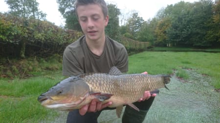 Thomas Macdonald-Ames with a 10lb grass carp he rescued from an orchard near Hay-on-Wye